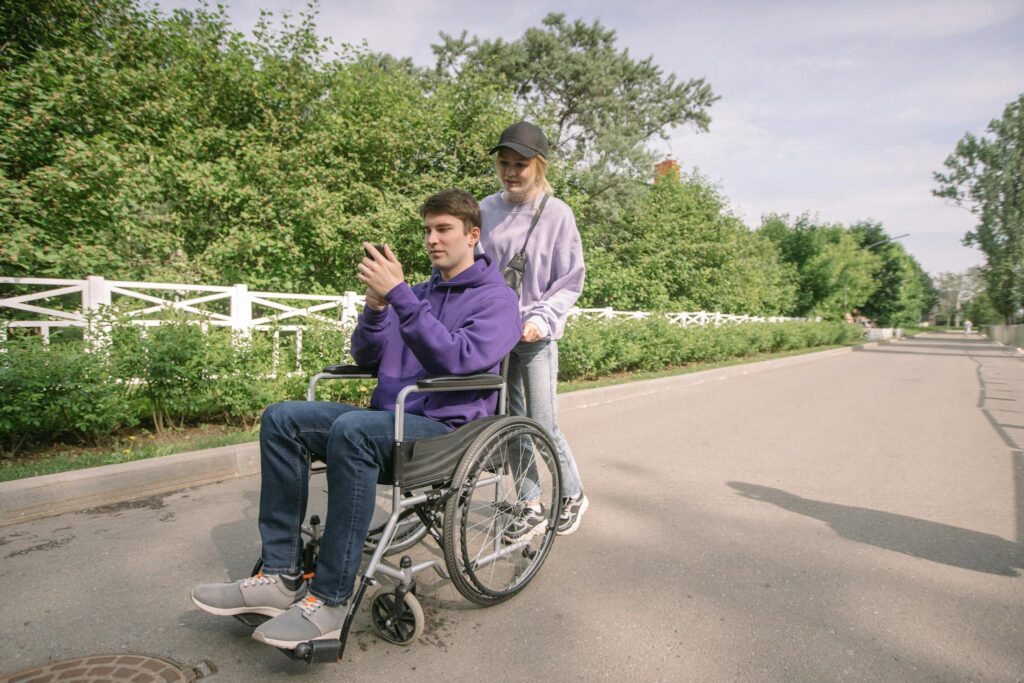 Woman Pushing the Wheelchair with a Man